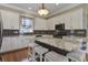 Bright kitchen features granite countertops, an island with seating, and ample cabinet space, providing a functional cooking area at 136 Heart Pine Cir, Summerville, SC 29485