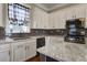 Modern kitchen features stainless steel appliances and a sink with black and white checkered curtains at 136 Heart Pine Cir, Summerville, SC 29485