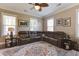 Comfortable living room featuring a sectional sofa, stylish rug, and windows for natural light at 136 Heart Pine Cir, Summerville, SC 29485