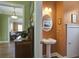 Charming powder room with pedestal sink, round mirror, and decorative lighting at 136 Heart Pine Cir, Summerville, SC 29485