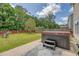 A backyard featuring a hot tub, a small patio and an American flag in the background at 139 Gaslight Blvd, Summerville, SC 29483