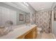 Well-lit bathroom featuring a large mirror and a shower with patterned curtain at 139 Gaslight Blvd, Summerville, SC 29483