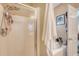 Neutral colored bathroom with glass shower, towel hanging on the wall and additional shelving and storage at 139 Gaslight Blvd, Summerville, SC 29483