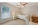 Comfortable bedroom with carpet, ceiling fan, and a bright window illuminating the space at 139 Gaslight Blvd, Summerville, SC 29483
