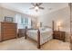 Cozy bedroom boasts natural light, a ceiling fan, comfortable bed, and wooden furnishings for a relaxing retreat at 139 Gaslight Blvd, Summerville, SC 29483