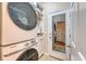 Modern laundry room with stacked washer and dryer units and built-in shelving at 139 Gaslight Blvd, Summerville, SC 29483