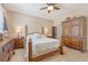 An inviting main bedroom featuring a ceiling fan, a wooden armoire, and a four-poster bed with white bedding at 139 Gaslight Blvd, Summerville, SC 29483