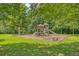 Community playground with slides, swings, and benches nestled among mature shade trees, providing fun for all at 139 Gaslight Blvd, Summerville, SC 29483