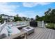 Spacious backyard deck featuring an outdoor lounge area, grill, fire pit, and waterfront views at 1464 Stratton Pl, Mount Pleasant, SC 29466