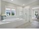This bathroom features a soaking tub, a glass shower and plenty of natural light at 1464 Stratton Pl, Mount Pleasant, SC 29466
