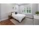 Cozy bedroom showcasing a comfortable bed, a bedside table, and natural light from the window at 1464 Stratton Pl, Mount Pleasant, SC 29466