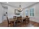 Elegant dining room with hardwood floors, chandelier, and natural light from shuttered windows at 1464 Stratton Pl, Mount Pleasant, SC 29466