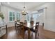 Elegant dining room with hardwood floors, chandelier, and natural light from shuttered windows at 1464 Stratton Pl, Mount Pleasant, SC 29466