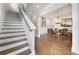 Traditional dining room features a wooden table, staircase, and hardwood floors at 1464 Stratton Pl, Mount Pleasant, SC 29466