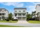 Inviting two-story home with double front porches, a well-kept lawn, and a two-car garage at 1464 Stratton Pl, Mount Pleasant, SC 29466