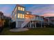 The backyard features a cozy patio space under the home's raised foundation at 1464 Stratton Pl, Mount Pleasant, SC 29466