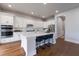 Modern kitchen with stainless steel appliances, white cabinets, and an island with barstool seating at 1464 Stratton Pl, Mount Pleasant, SC 29466