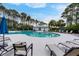 Luxurious pool area with ample seating, umbrellas, and modern design at 1464 Stratton Pl, Mount Pleasant, SC 29466