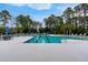 Large community pool with lounge chairs and umbrellas for relaxing poolside at 1464 Stratton Pl, Mount Pleasant, SC 29466