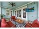 Inviting outdoor porch with a ceiling fan, an outdoor television, and comfortable seating at 1464 Stratton Pl, Mount Pleasant, SC 29466