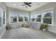 Bright sunroom with white trim windows, light wood floors, and lots of natural light at 1464 Stratton Pl, Mount Pleasant, SC 29466
