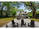Expansive backyard with a patio, outdoor seating, and lush greenery perfect for entertaining and relaxation at 1515 N Lakeshore Dr, Mount Pleasant, SC 29466