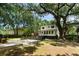 Serene backyard with mature trees, patio area, and a spacious lawn perfect for outdoor activities and relaxation at 1515 N Lakeshore Dr, Mount Pleasant, SC 29466