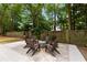 Cozy backyard featuring a patio with a fire pit and surrounded by mature trees, creating a private outdoor living space at 1515 N Lakeshore Dr, Mount Pleasant, SC 29466