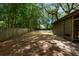 Large backyard featuring green grass, mature trees and a shed, creating a private and serene outdoor space at 1515 N Lakeshore Dr, Mount Pleasant, SC 29466