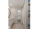 Modern bathroom features a vanity sink, toilet, a round mirror and view into bedroom at 1515 N Lakeshore Dr, Mount Pleasant, SC 29466