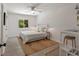 Bright bedroom features a window, white walls, hardwood floors, and a ceiling fan at 1515 N Lakeshore Dr, Mount Pleasant, SC 29466