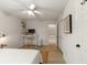 Bright bedroom features a desk, white walls, hardwood floors, and a ceiling fan at 1515 N Lakeshore Dr, Mount Pleasant, SC 29466