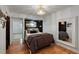 Cozy bedroom with hardwood floors, built-in shelving, accent lighting, and a large mirror at 1515 N Lakeshore Dr, Mount Pleasant, SC 29466