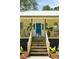 Inviting front entrance features a vibrant blue door, wooden steps, porch, and well-maintained landscaping at 1515 N Lakeshore Dr, Mount Pleasant, SC 29466