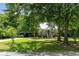 Charming home with a metal roof, front porch, manicured lawn, and mature trees offering a tranquil and picturesque setting at 1515 N Lakeshore Dr, Mount Pleasant, SC 29466
