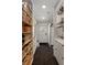 Hallway with ample storage cabinets and shelves for organization leading to exterior door at 1515 N Lakeshore Dr, Mount Pleasant, SC 29466