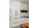 Kitchen with white cabinetry, dark hardware, and open shelving with wood accents at 1515 N Lakeshore Dr, Mount Pleasant, SC 29466