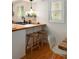 Bright kitchen featuring wood breakfast bar, stools, and unique hexagon backsplash at 1515 N Lakeshore Dr, Mount Pleasant, SC 29466