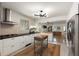 Spacious kitchen featuring white cabinets, black countertops, and updated appliances at 1515 N Lakeshore Dr, Mount Pleasant, SC 29466
