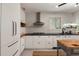 Open kitchen featuring white cabinets, black countertops, and modern appliances at 1515 N Lakeshore Dr, Mount Pleasant, SC 29466