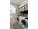 Laundry room with modern washer and dryer, and black flower wallpaper at 1515 N Lakeshore Dr, Mount Pleasant, SC 29466