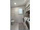 Modern laundry room with white interior, featuring a washer, dryer, and toilet at 1515 N Lakeshore Dr, Mount Pleasant, SC 29466