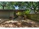 Backyard shed structure with ample storage and adjacent wood pile, offering convenience and rustic charm at 1515 N Lakeshore Dr, Mount Pleasant, SC 29466