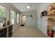 Bright sun room featuring a mounted TV, multiple windows, decorative shelves, and wood paneled walls at 1515 N Lakeshore Dr, Mount Pleasant, SC 29466