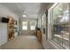 Sun room with paneled walls, fan, and windows that bring natural light, and decorative shelves at 1515 N Lakeshore Dr, Mount Pleasant, SC 29466