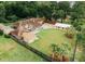 Aerial view showcases a large property with expansive green lawns, a pool, and multiple structures at 1551 Hutton Pl, Charleston, SC 29407