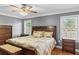 Comfortable bedroom with hardwood floors, ceiling fan, and ample natural light at 1551 Hutton Pl, Charleston, SC 29407