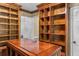 Spacious closet with custom wood shelving and a center desk island at 1551 Hutton Pl, Charleston, SC 29407