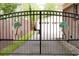 Driveway entrance with black metal gate and palm tree ornamentation at 1551 Hutton Pl, Charleston, SC 29407
