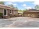 Brick house exterior featuring a detached garage, outdoor gazebo, and mature landscaping at 1551 Hutton Pl, Charleston, SC 29407